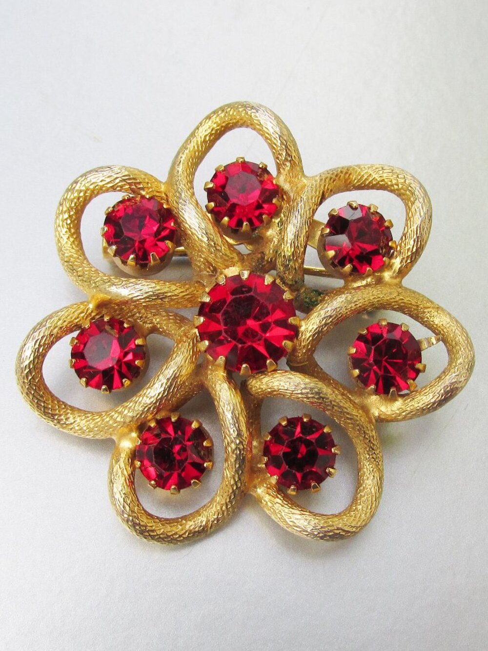 Vintage Haskell Like Red Rhinestone Textured Gold Tone Flower Brooch Pin